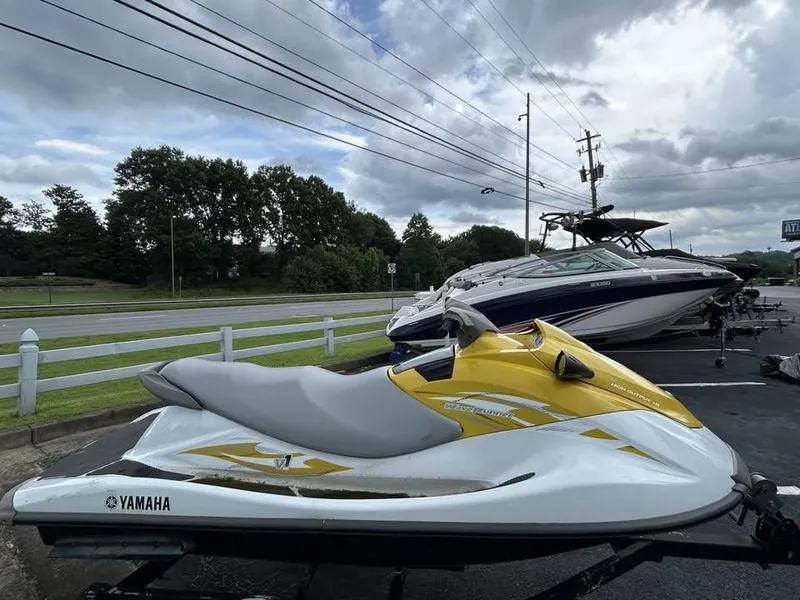 Slide: The Image of 2016 Yamaha WaveRunner VX jet ski in parking lot, cloudy sky background. - 2