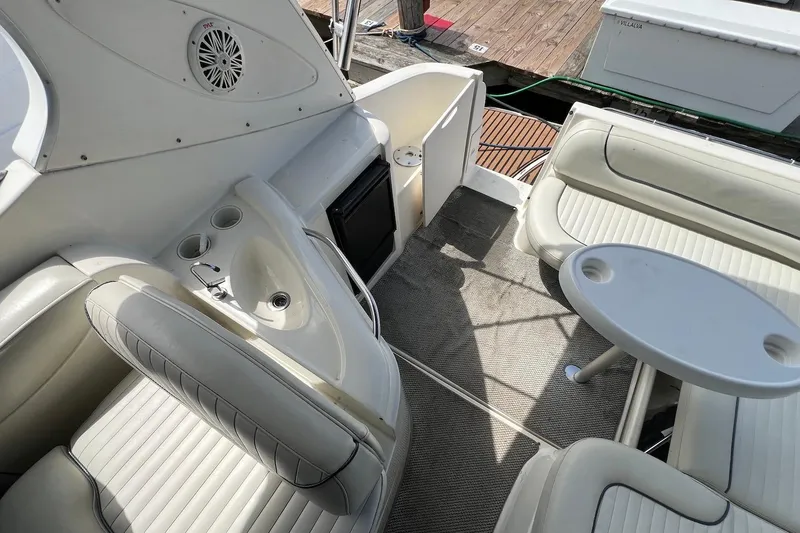 Slide: The Image of 2006 Maxum 3100 SE boat interior with seating, table, and sink. - 10