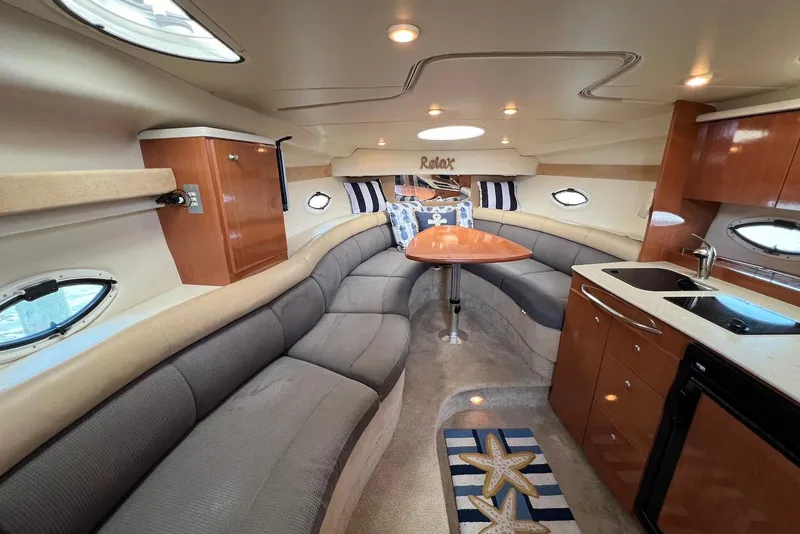 Slide: The Image of Luxurious interior of 2006 Maxum 3100 SE yacht with plush seating and kitchenette. - 12