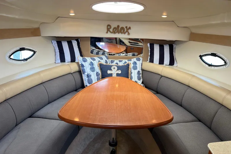 Slide: The Image of Luxurious 2006 Maxum 3100 SE boat interior with cozy seating and decorative pillows. - 14