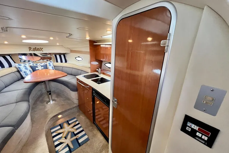 Slide: The Image of Interior of 2006 Maxum 3100 SE boat with cozy seating and kitchenette. - 15