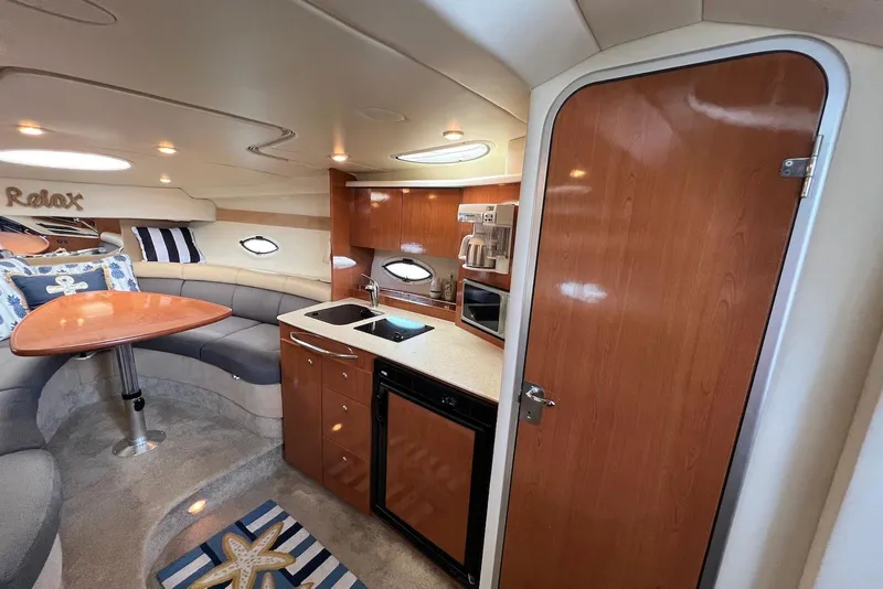 Slide: The Image of Interior of 2006 Maxum 3100 SE yacht with kitchenette and seating area. - 18