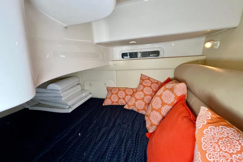 Slide: The Image of 2006 Maxum 3100 SE cabin interior with colorful cushions and compact sleeping area. - 19