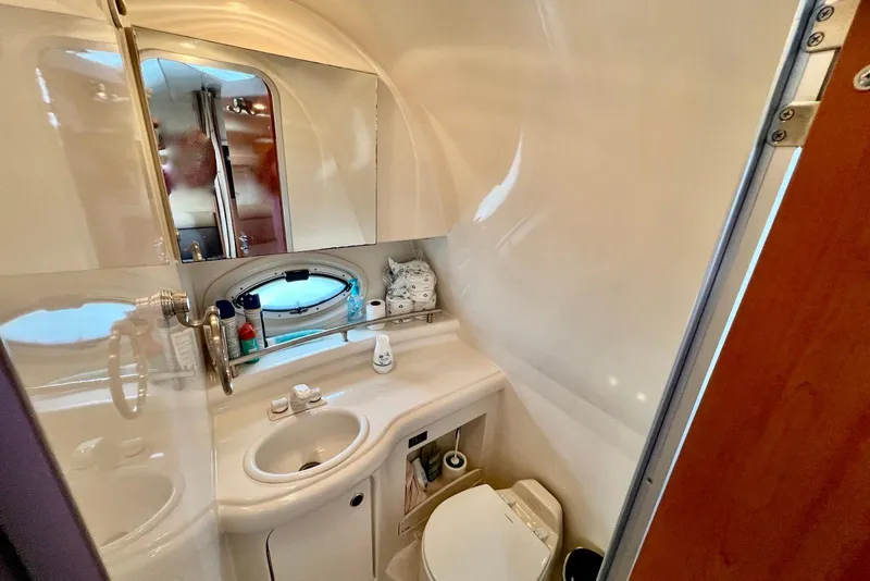 Slide: The Image of 2006 Maxum 3100 SE boat bathroom with sink, mirror, and porthole window. - 20