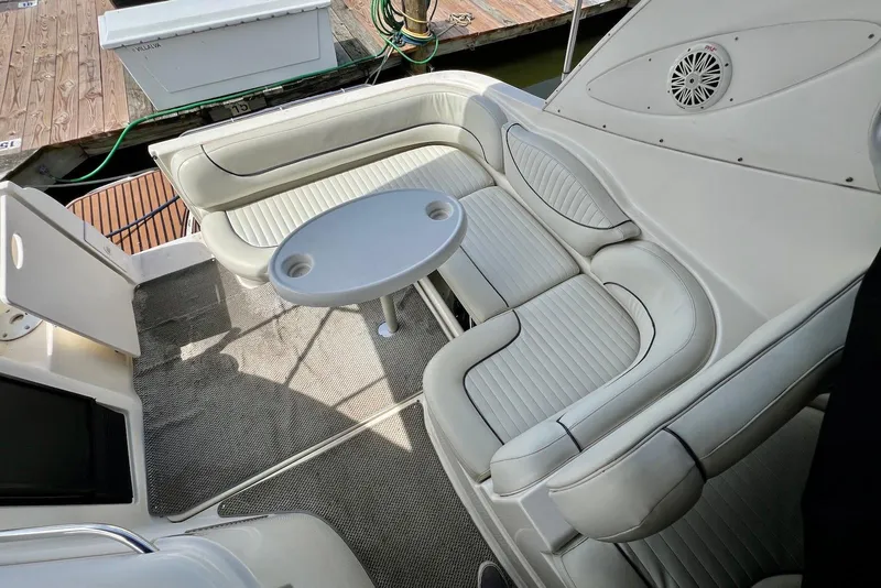 Slide: The Image of 2006 Maxum 3100 SE boat interior with white seating and round table. - 9