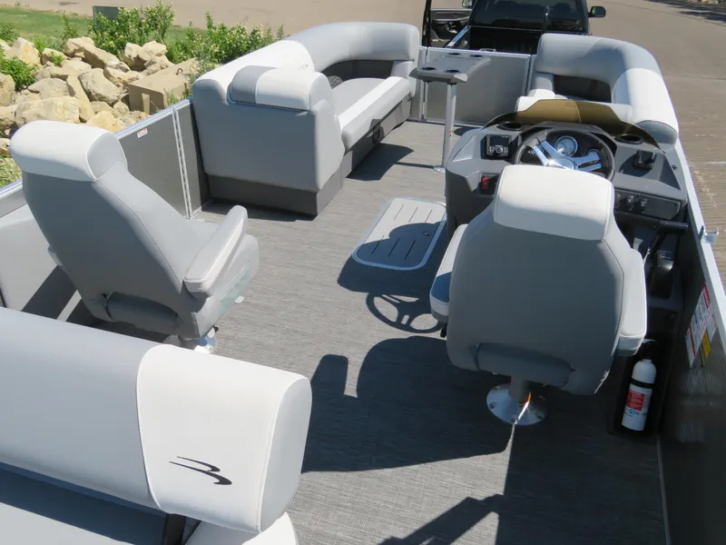 Slide: The Image of 2024 Bennington S22 SB pontoon boat interior with gray seating and steering console. - 10