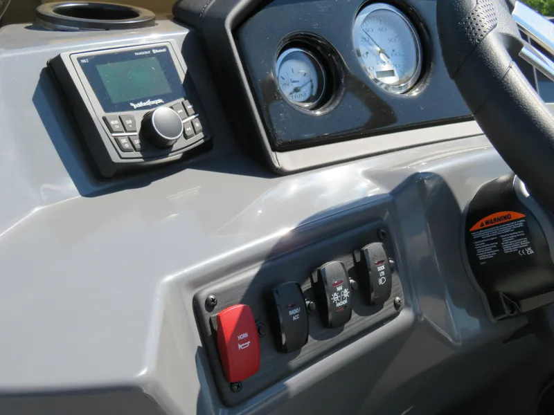 Slide: The Image of 2024 Bennington S22 SB dashboard with controls, gauges, and stereo system. - 11