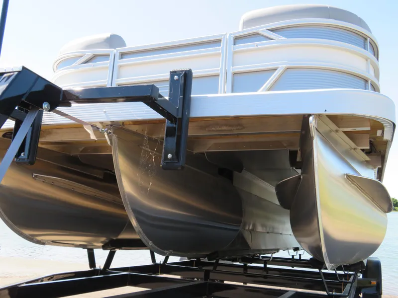 Slide: The Image of 2024 Bennington S22 SB pontoon boat on trailer, showcasing sleek aluminum pontoons. - 12