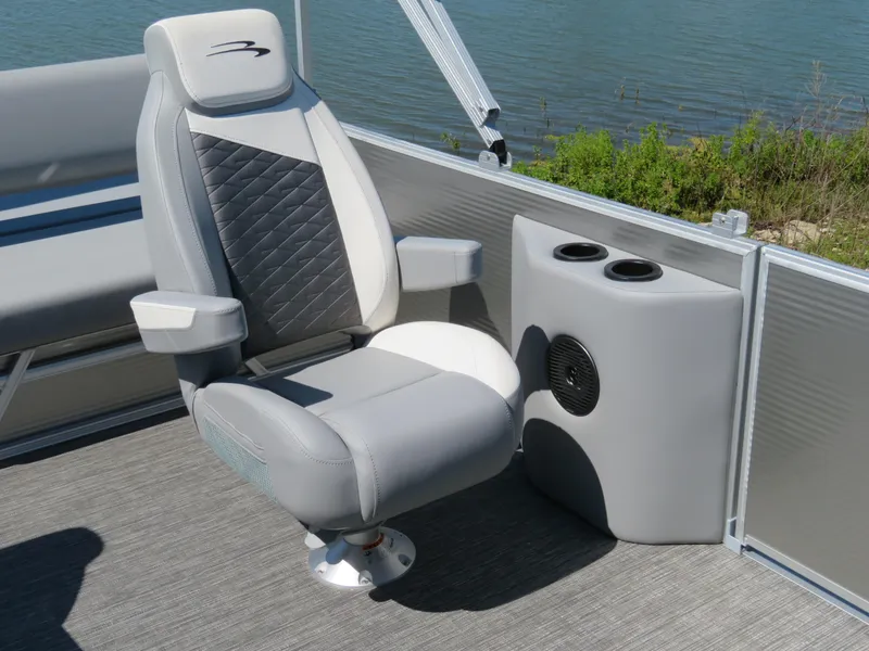 Slide: The Image of 2024 Bennington S22 SB boat seat with cup holders, near water. - 6