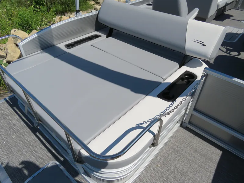 Slide: The Image of 2024 Bennington S22 SB boat with gray cushioned seating and sleek design. - 9