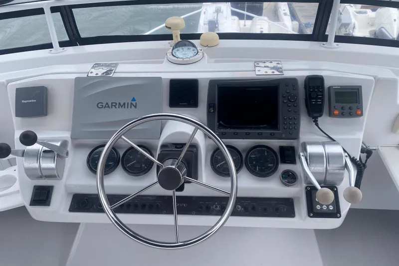 Slide: The Image of Mainship 430 Trawler 1999 helm with Garmin navigation and control instruments. - 13