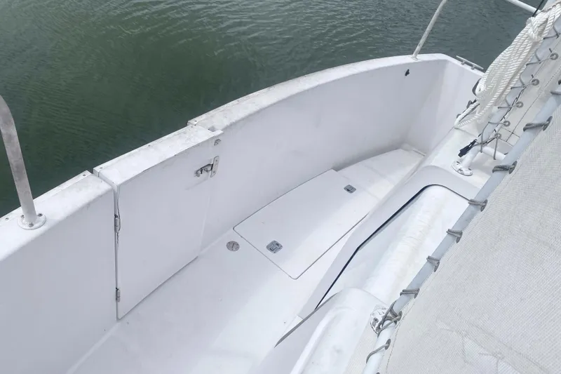 Slide: The Image of 1999 Mainship 430 Trawler deck with white railing and water view. - 17