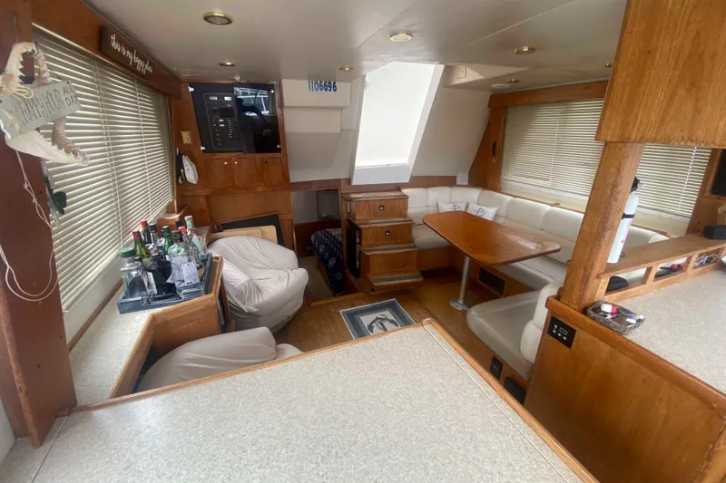 Slide: The Image of 1999 Mainship 430 Trawler interior with seating, table, and bar area. - 20