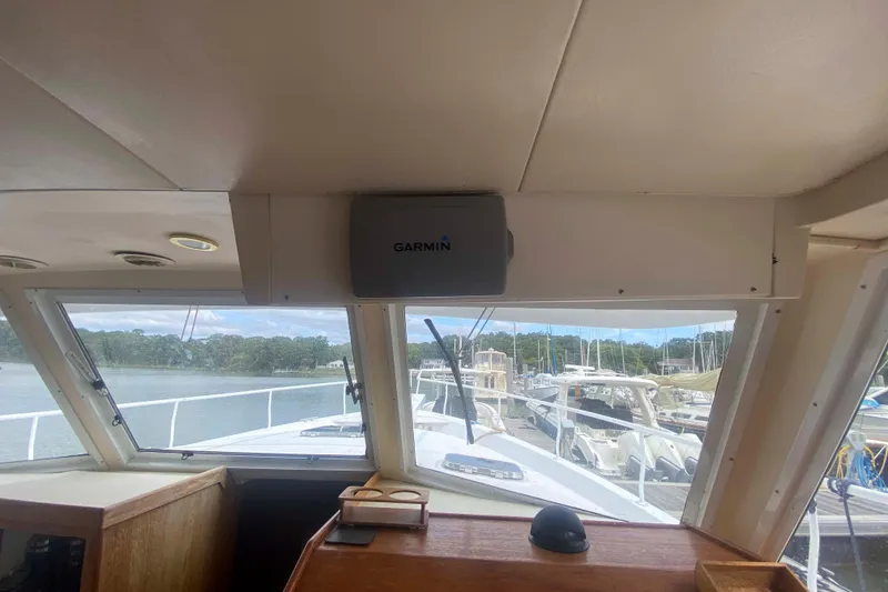 Slide: The Image of Interior view of 1999 Mainship 430 Trawler with Garmin navigation system. - 24