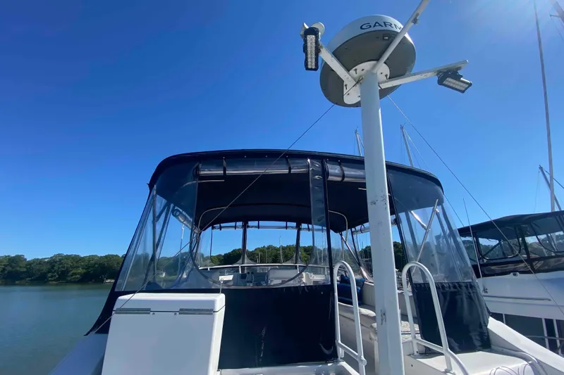 Slide: The Image of 1999 Mainship 430 Trawler with Garmin radar, docked under clear blue sky. - 3