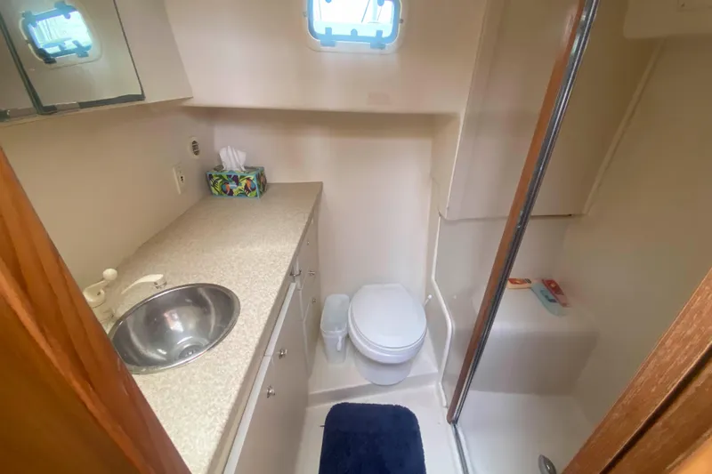Slide: The Image of 1999 Mainship 430 Trawler bathroom with sink, toilet, and shower. - 30