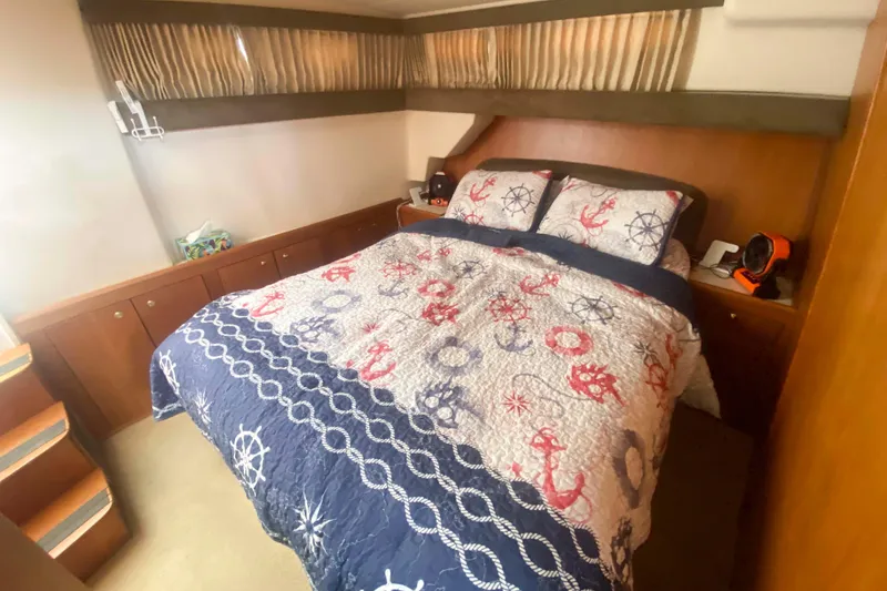 Slide: The Image of Cozy bedroom in 1999 Mainship 430 Trawler with nautical-themed bedding. - 35