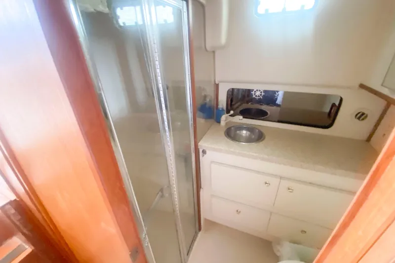 Slide: The Image of Bathroom interior of 1999 Mainship 430 Trawler with shower and sink. - 38