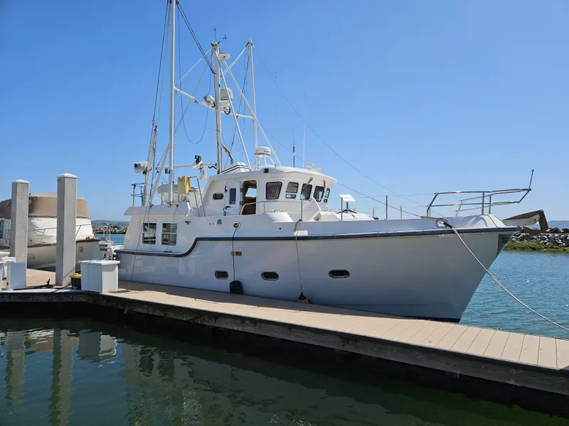 The Image of 2002 Nordhavn Trawler docked at marina under clear blue sky. - 0