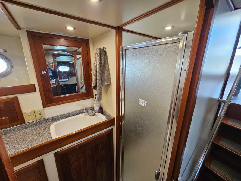 Slide: The Image of Bathroom interior of a 2002 Nordhavn Trawler with shower, sink, and mirror. - 29