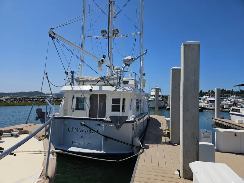 Slide: The Image of 2002 Nordhavn Trawler docked at marina under clear blue sky. - 3