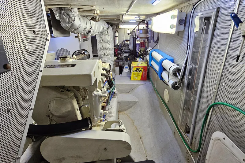 Slide: The Image of Engine room of a 2002 Nordhavn Trawler, featuring machinery and equipment. - 38