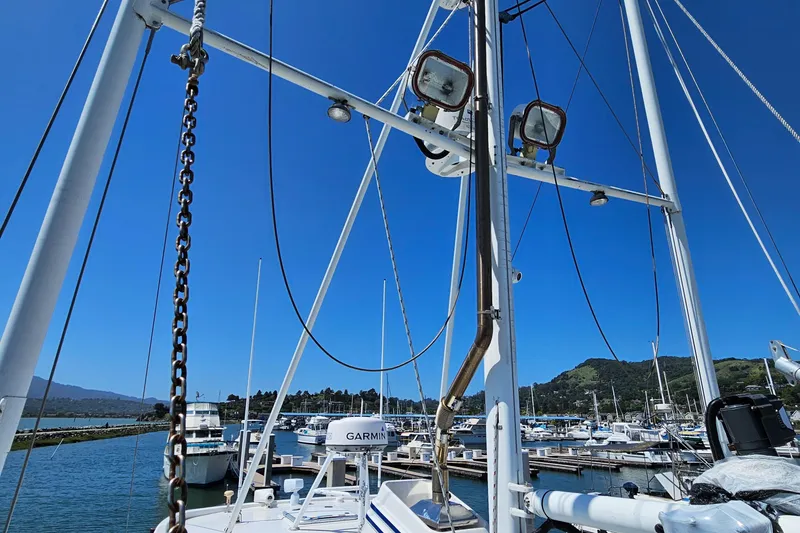 Slide: The Image of 2002 Nordhavn Trawler in marina, clear blue sky, masts and equipment visible. - 40