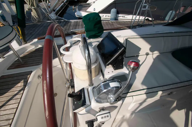 Slide: The Image of Cockpit of 2002 Beneteau 473 sailboat with steering wheel and navigation controls. - 11