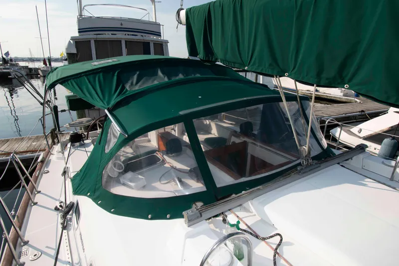 Slide: The Image of 2002 Beneteau 473 sailboat with green canopy docked at marina. - 15