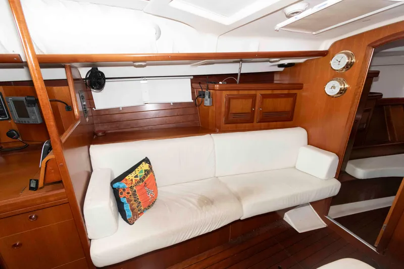 Slide: The Image of Interior of 2002 Beneteau 473 yacht with white sofa and wooden cabinetry. - 21