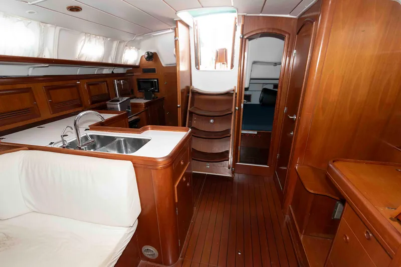 Slide: The Image of Interior of 2002 Beneteau 473 yacht with wooden cabinetry and modern amenities. - 23