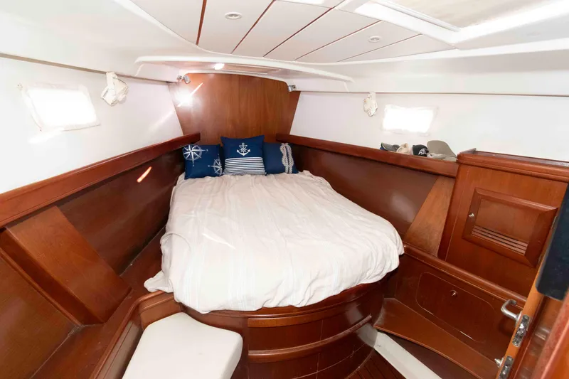 Slide: The Image of Cozy cabin interior of 2002 Beneteau 473 sailboat with wooden finish and nautical decor. - 24