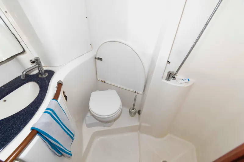 Slide: The Image of Bathroom of 2002 Beneteau 473 yacht with sink, toilet, and shower. - 25
