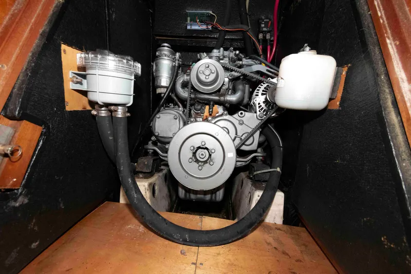 Slide: The Image of Engine compartment of a 2002 Beneteau 473 sailboat, showcasing mechanical components and hoses. - 29