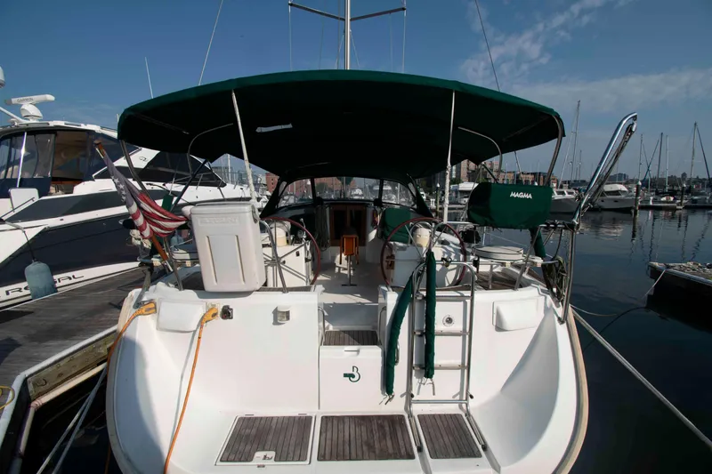 Slide: The Image of Beneteau 473 sailboat, 2002 model, docked at marina with green canopy. - 4