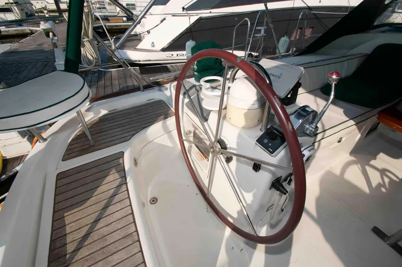 Slide: The Image of Cockpit of a 2002 Beneteau 473 sailboat with steering wheel and navigation equipment. - 7