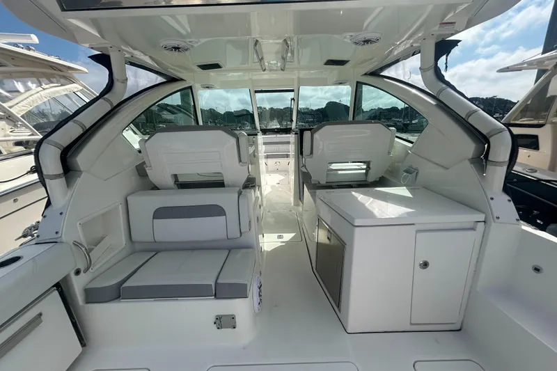 Slide: The Image of 2023 Pursuit DC326 boat interior with white seating and modern design. - 10