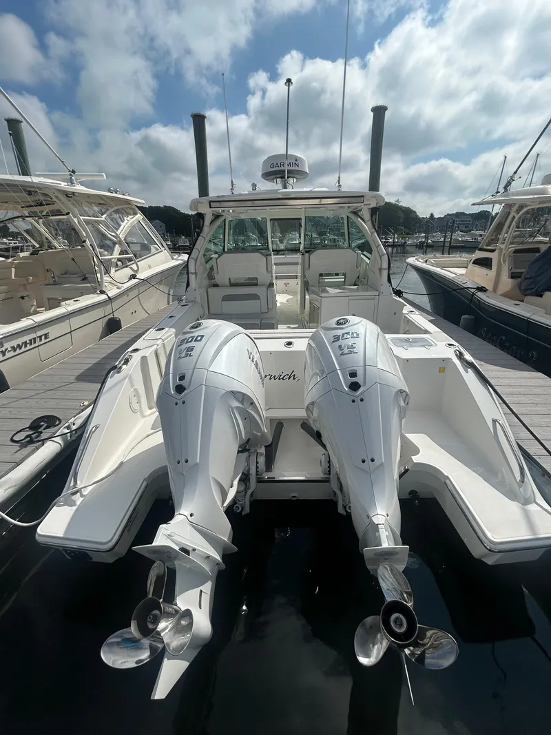 Slide: The Image of 2023 Pursuit DC326 boat with twin 300 V6 engines docked at marina. - 3