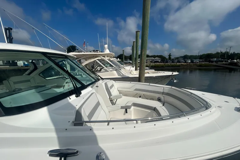 Slide: The Image of 2023 Pursuit DC326 boat interior with seating and storage, showcasing modern design and functionality. - 9