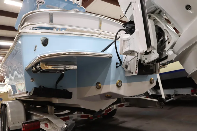 Slide: The Image of 2024 SeaCraft 23CC boat on trailer, showcasing rear view and motor details. - 14