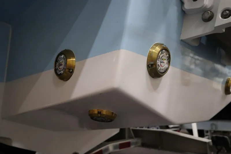 Slide: The Image of 2024 SeaCraft 23CC boat hull with brass fittings and blue-white color scheme. - 16