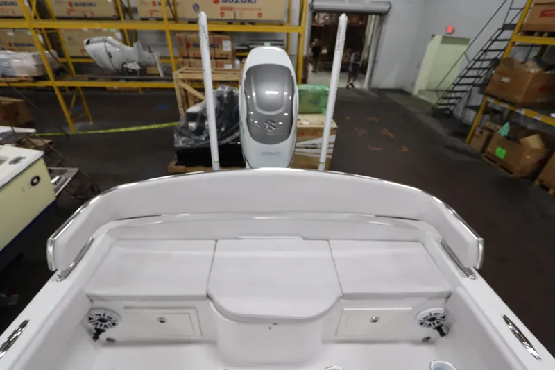 Slide: The Image of 2024 SeaCraft 23CC boat interior with storage compartments and speakers in a warehouse setting. - 18