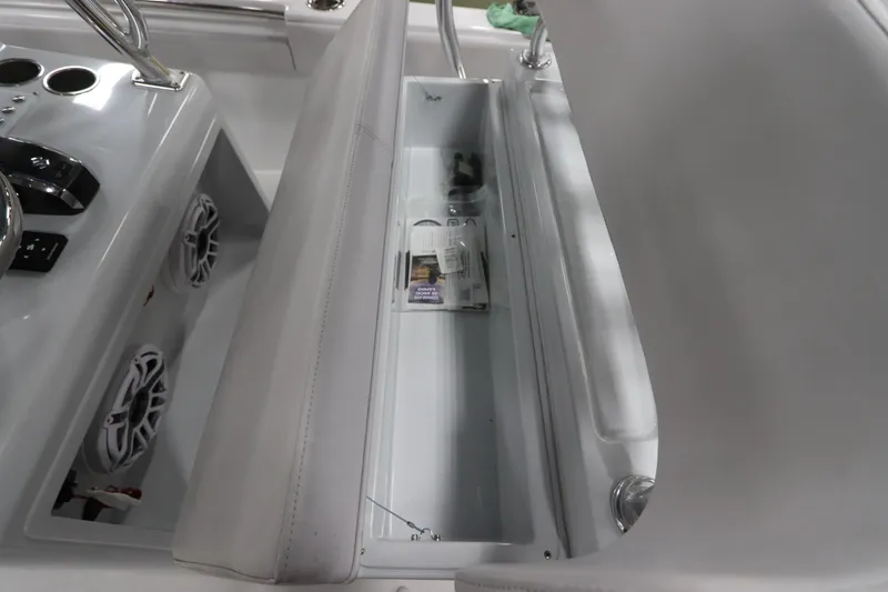 Slide: The Image of 2024 SeaCraft 23CC boat interior with storage compartment and control panel. - 25