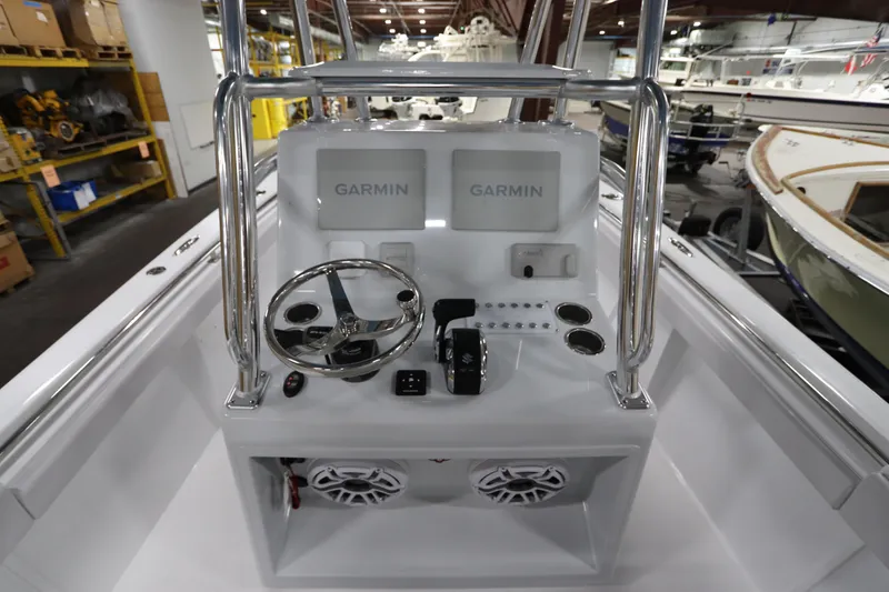 Slide: The Image of 2024 SeaCraft 23CC boat console with Garmin displays and steering wheel in a showroom. - 27