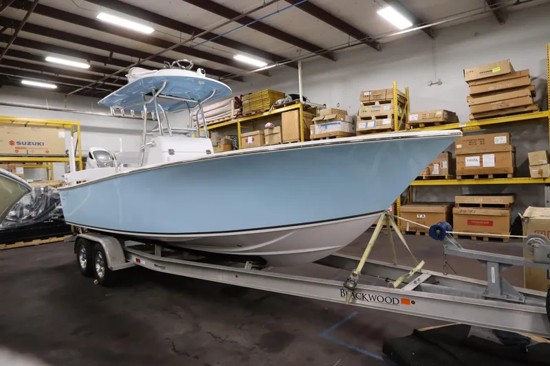 Slide: The Image of 2024 SeaCraft 23CC boat on trailer in warehouse setting. - 3