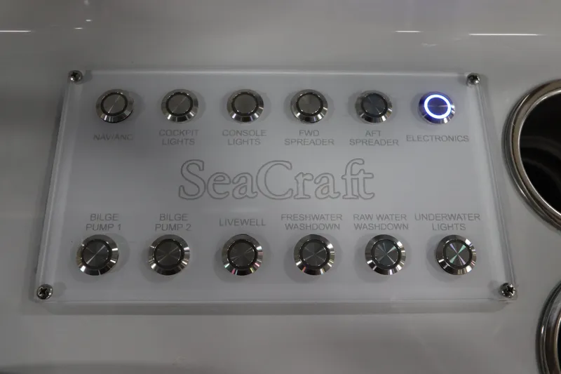 Slide: The Image of Control panel of 2024 SeaCraft 23CC boat with labeled buttons for various functions. - 34