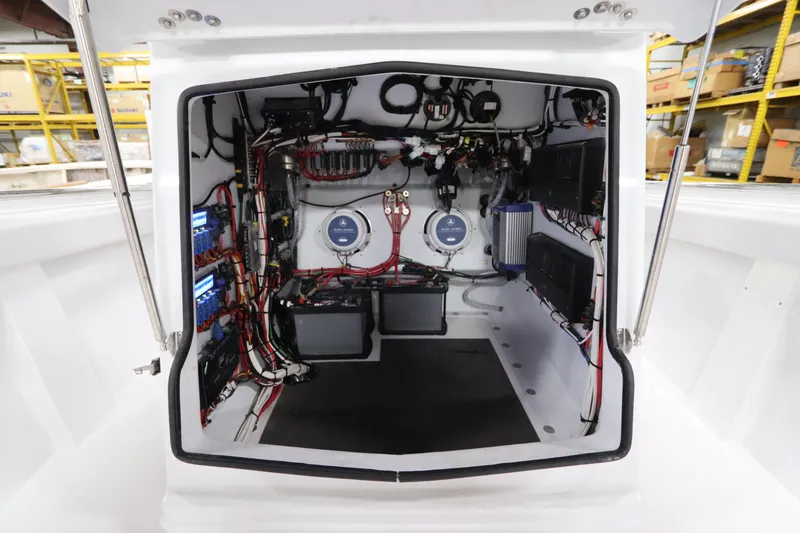 Slide: The Image of 2024 SeaCraft 23CC boat electrical compartment with wiring and components. - 44