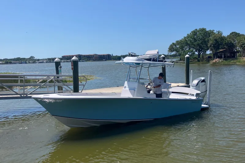 The Image of 2024 SeaCraft 23CC boat docked on a sunny day by the water. - 0