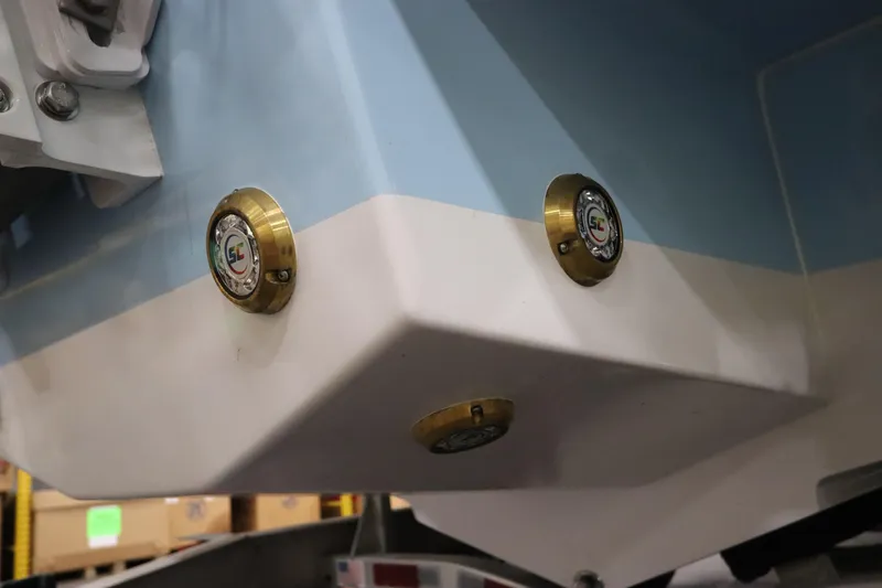 Slide: The Image of 2024 SeaCraft 23CC boat hull with brass fittings, close-up view. - 12