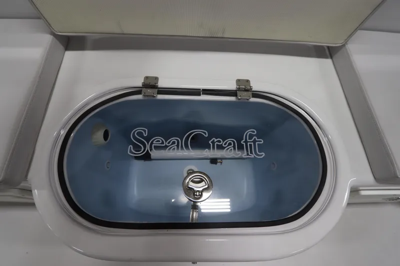 Slide: The Image of 2024 SeaCraft 23CC livewell with logo, featuring a secure latch and sleek design. - 19